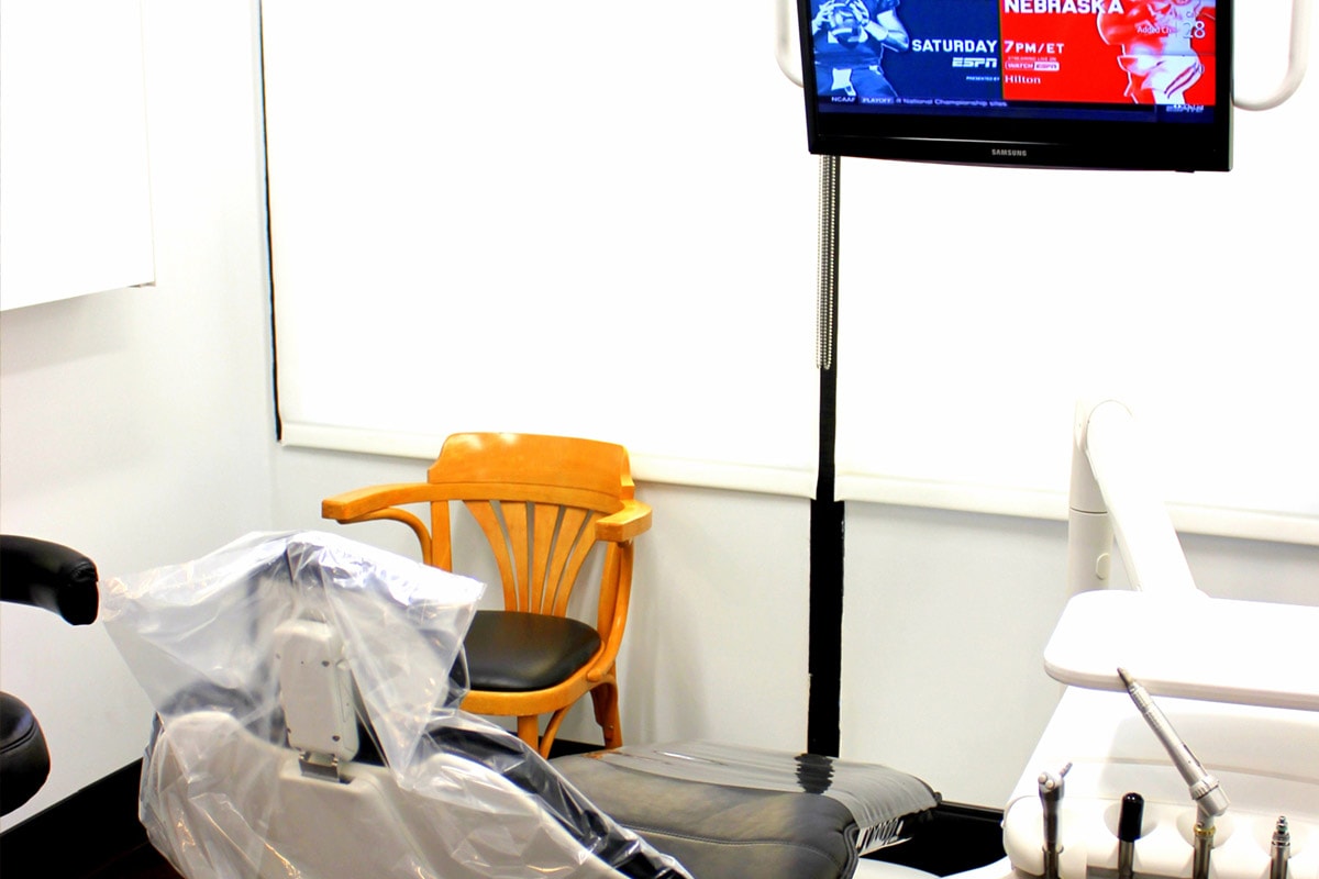 Treatment room with ceiling-mounted TV